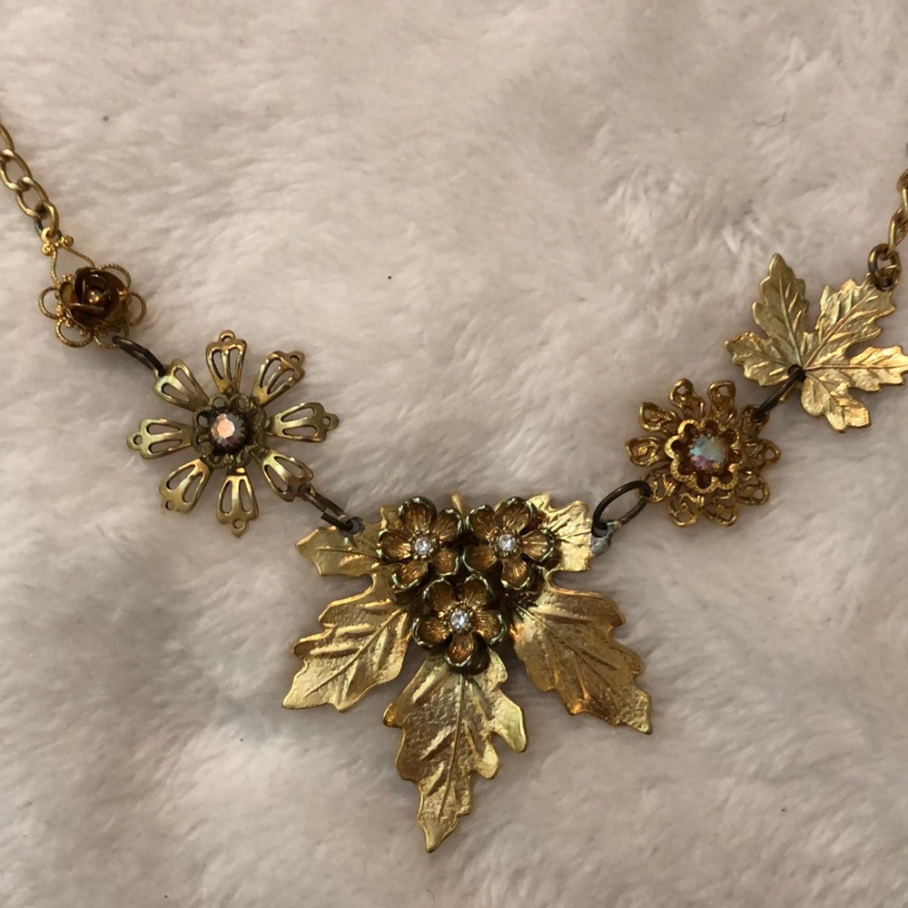 Gold necklace of flowers and leaves.